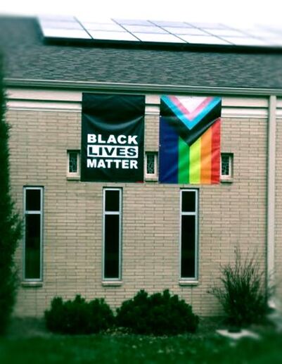 LGBTQA Rainbow Flag Displays Next to Black Lives Matter Banner
